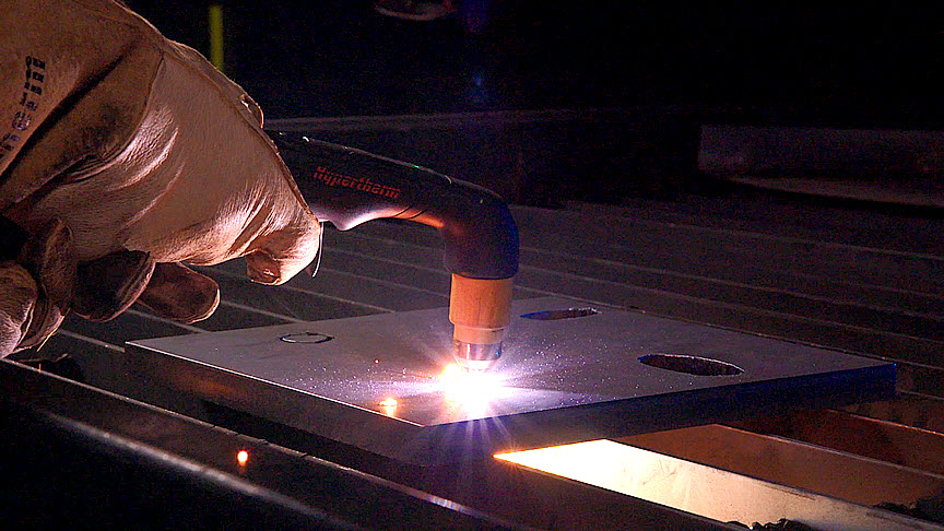 This image shows the torch cutting a workpiece.