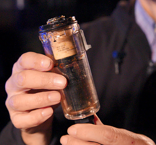 This image shows a dirty air filter bowl.