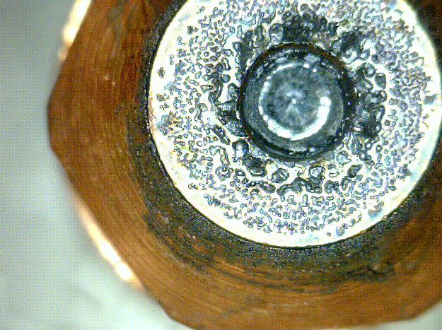 This image shows an example used electrode with pitting that extends beyond hafnium.